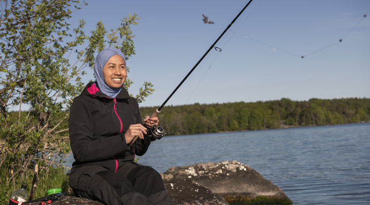 Kvinna med hijab fiskar